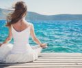 Woman meditating at the sea
