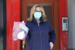Diane Hatz holding an N95 mask outside her NYC apartment