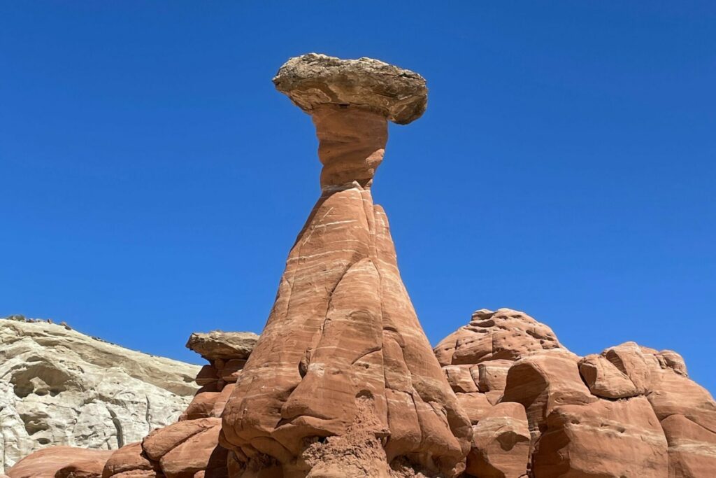 Large red rock formation with deep blue sky